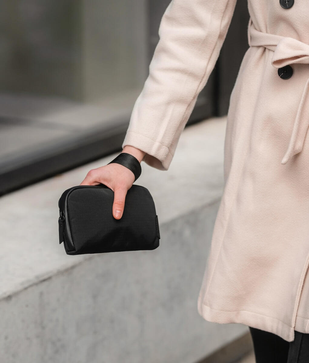 Woman holding the Flight Pouch