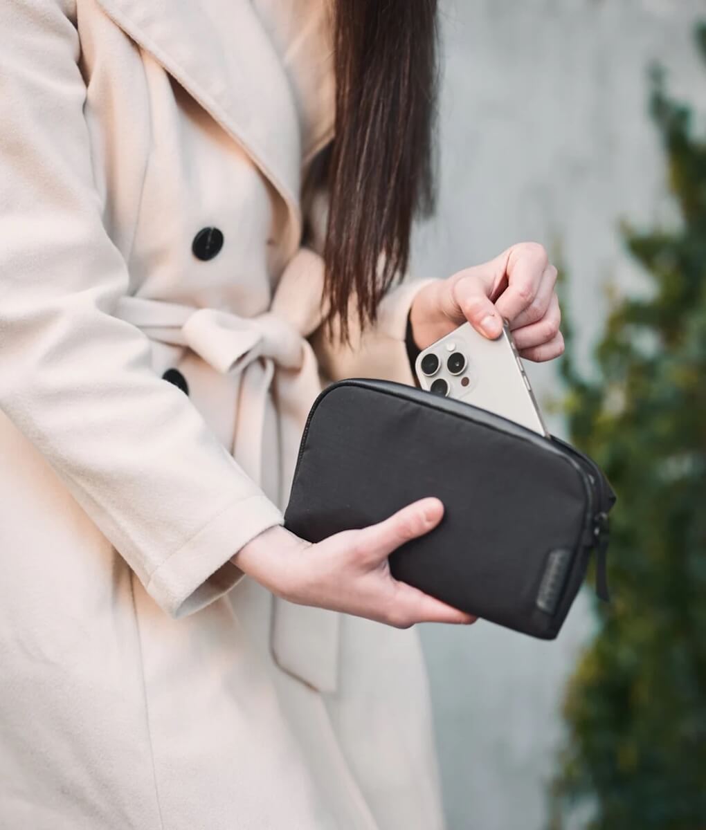 Woman pulling iPhone out of Flight Pouch