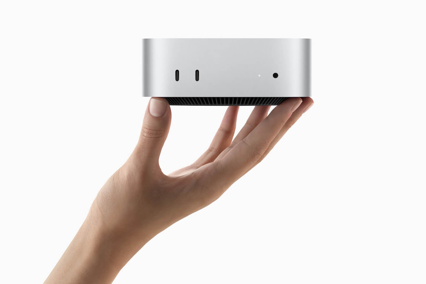 Person holding up M4 Mac Mini