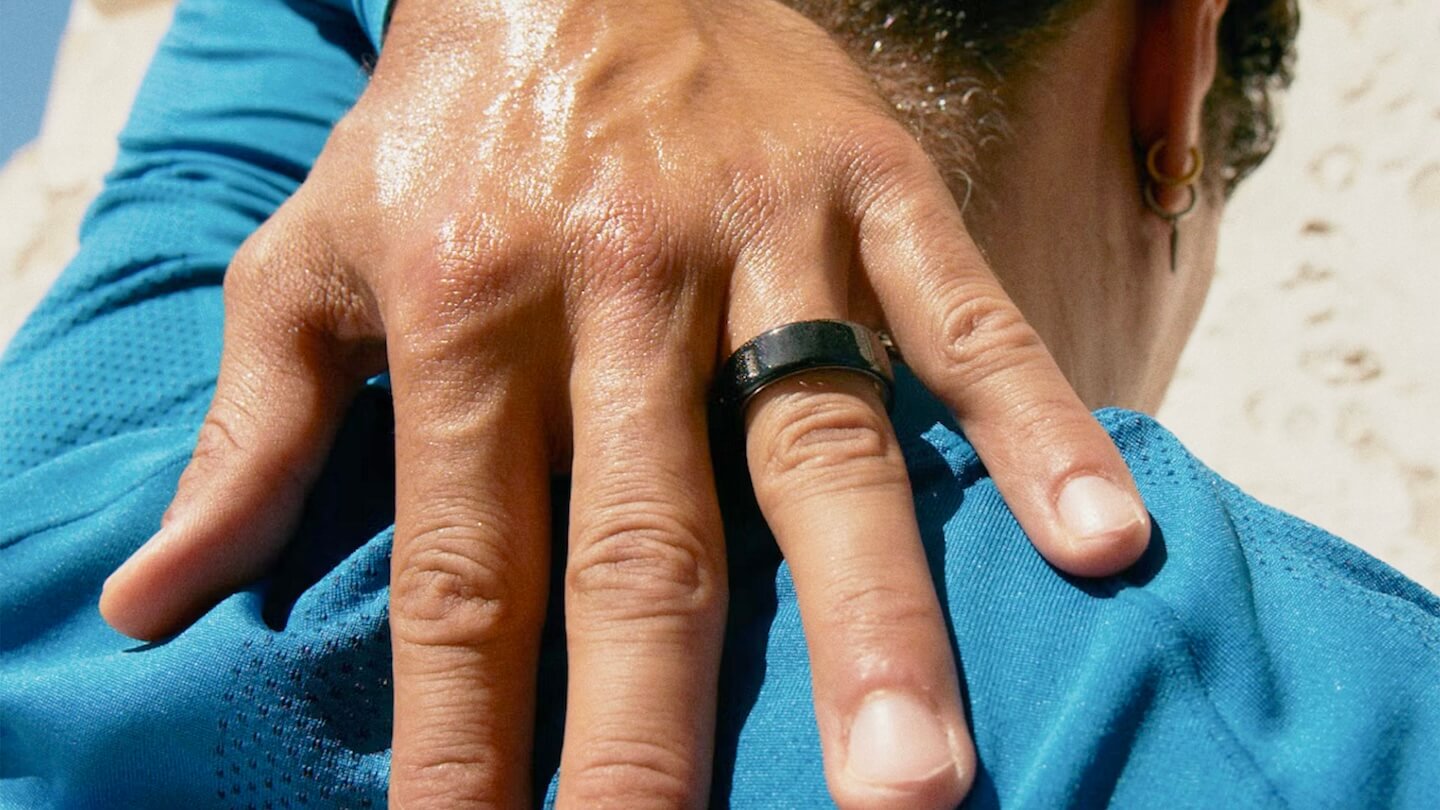 Man reaching behind back and stretching while wearing the Oura Ring 4