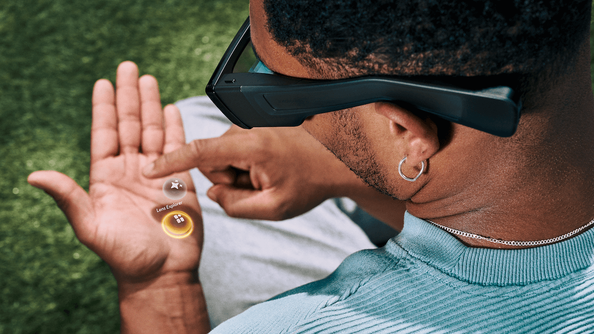 Man with spectacles looking at virtual menu on palm