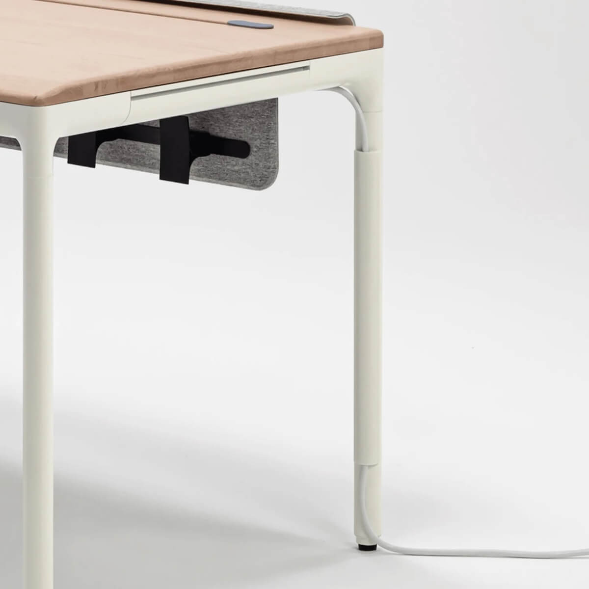 the close up of the desk showing power running down the leg of the desk